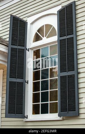 Large exterior view of a window with a curved semi circle top portion Stock Photo