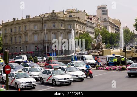 Traffic on a road in front of a palace, Cibeles Fountain, Palacio de Linares, Plaza de Cibeles, Madrid, Spain Stock Photo