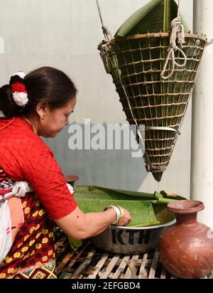 Guwahati, Assam, India. 17th Feb, 2021. A Mising tribal woman preparing traditional rice beer during Ali-Aye-Ligang festival in Guwahati, India on 17 February 2021. Ali-Aye-Ligang, the main harvest festival of the ethnic Mising community people, this spring festival associated with agriculture, especially with the beginning of the Ahu paddy cultivation. Credit: David Talukdar/ZUMA Wire/Alamy Live News Stock Photo