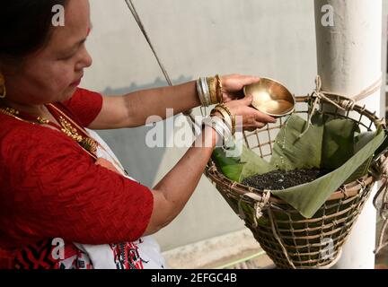 Guwahati, Assam, India. 17th Feb, 2021. A Mising tribal woman preparing traditional rice beer during Ali-Aye-Ligang festival in Guwahati, India on 17 February 2021. Ali-Aye-Ligang, the main harvest festival of the ethnic Mising community people, this spring festival associated with agriculture, especially with the beginning of the Ahu paddy cultivation. Credit: David Talukdar/ZUMA Wire/Alamy Live News Stock Photo