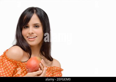 Mixed Race Woman Holding Mango to Cover Breasts Stock Photo - Alamy