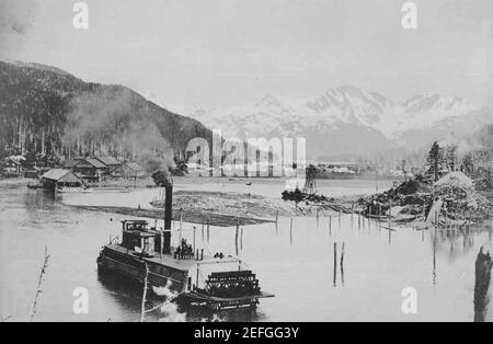 Odiak Slough showing steamboat, floating logs and construction activities of the Copper River and Northwestern Railway Company Stock Photo