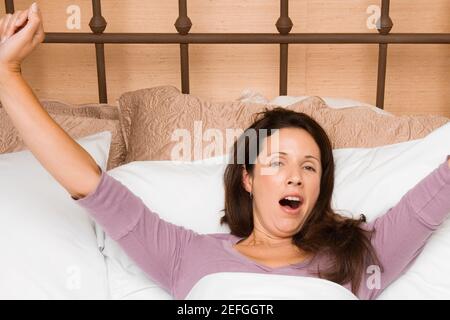 Portrait of a mid adult woman waking up Stock Photo