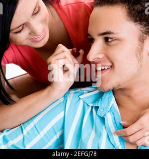 Portrait of a young woman feeding grapes to a young man Stock Photo