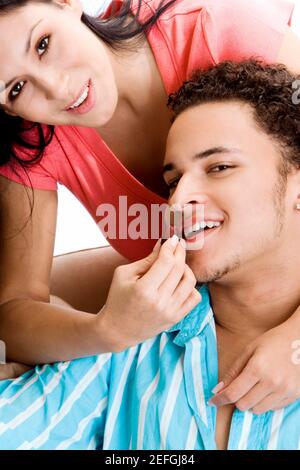 Portrait of a young woman feeding grapes to a young man Stock Photo