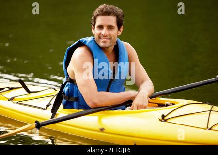 Portrait of a mid adult man sitting in a kayak Stock Photo
