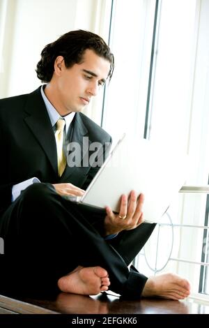 Businessman sitting and using a laptop Stock Photo