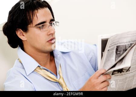 Close-up of a businessman reading a newspaper Stock Photo