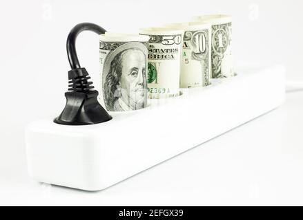 Power cord and us dollars, concept of expensive energy bills Stock Photo