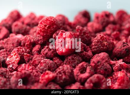 Heap of freeze dried raspberries close-up. Dehydrated food background Stock Photo