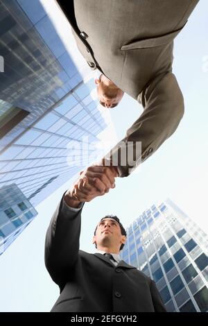 Low angle view of two businessmen shaking hands Stock Photo