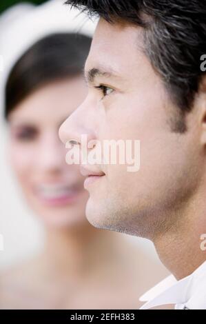 Womanly brunette bride in white dress with bridal veiling and