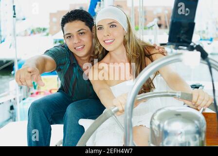 Close up of a young couple sitting in a boat and smiling Stock Photo