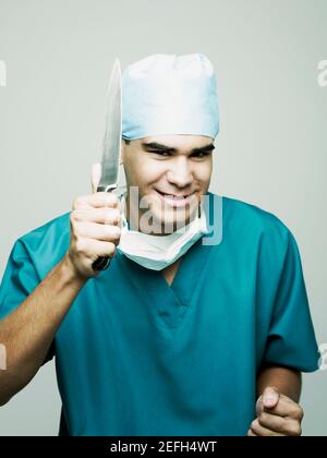 Portrait of a male surgeon holding a knife Stock Photo
