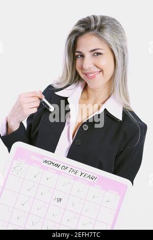 Close up of a businesswoman holding a progress report and smiling Stock Photo