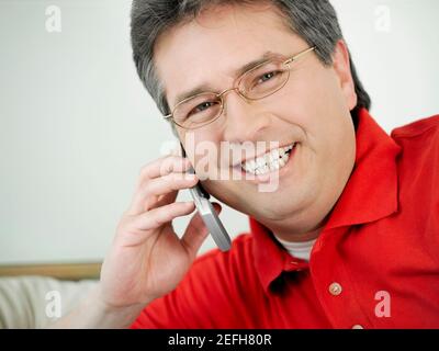 Portrait of a mature man talking on a mobile phone and smiling Stock Photo