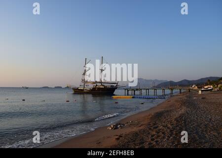 Large sailing ship in the Mediterranean sea in a pirate style in the open sea against a blue sky. The concept of summer holidays, sports, tourism. Pir Stock Photo