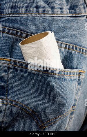 Close up of a paper towel roll in the pocket of a pair of jeans Stock Photo