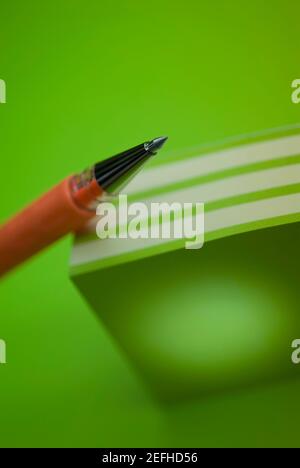 Close up of a pen on a stack of colored post it notes Stock Photo