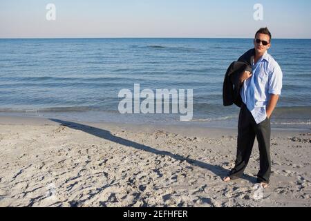 Young man standing on the beach Stock Photo