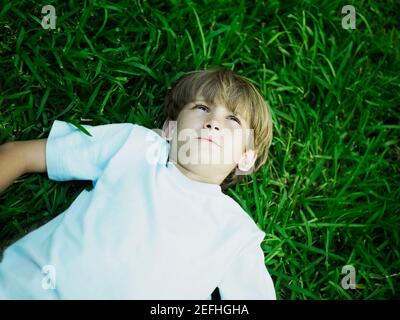 High angle view of a boy lying on the grass Stock Photo