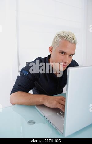 Portrait of a young man using a laptop Stock Photo