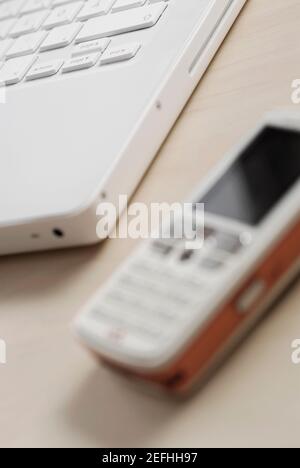 Close up of a mobile phone with a laptop Stock Photo