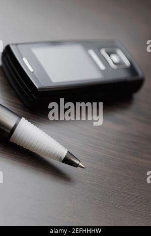 Close up of ball point pen with a mobile phone Stock Photo