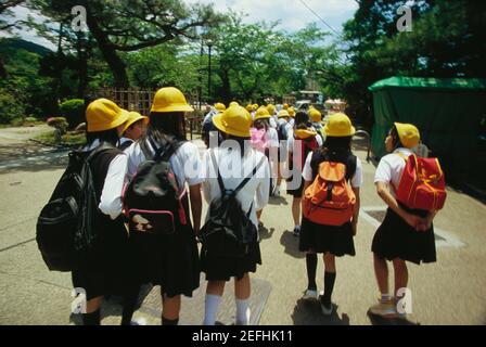 Group of schoolgirls walking on the road, Kyoto Prefecture, Japan Stock Photo