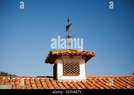 Low angle view of a weather vane on a rooftop Stock Photo