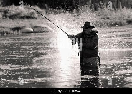 Big game fishing. fisher hold fish net. hobby. man checkered shirt on  ranch. fisherman with fishing rod. man in cowboy hat. western portrait.  Vintage style man. Wild West retro cowboy. fly fishing