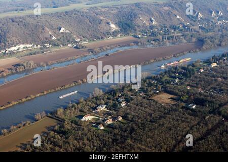Aerial photography of barges and transport boats sailing on the Seine river, in commune of Haute-Isle en Vexin, Val-d'Oise department (95780), Ile-de- Stock Photo