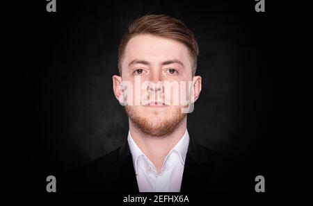 Intelligent man in a suit on a dark background. Stock Photo