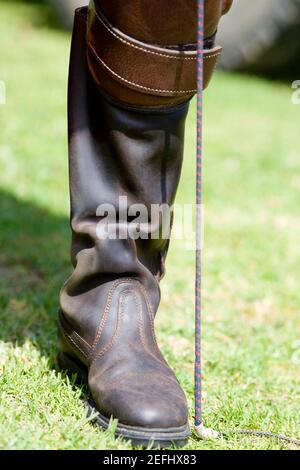 Close-up of a personÅ½s leg wearing a riding boot Stock Photo