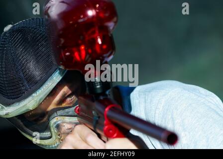 Close up of a man aiming with a paintball gun Stock Photo
