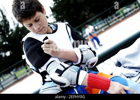 Close up of a boy getting dressed for ice hockey Stock Photo