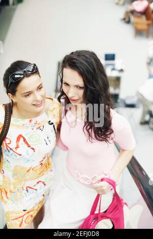 High angle view of two young women on an escalator Stock Photo