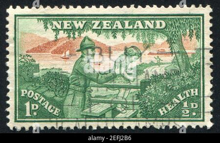 NEW ZEALAND - CIRCA 1945: stamp printed by New Zealand, shows Soldier Helping Child over Stile, circa 1945 Stock Photo