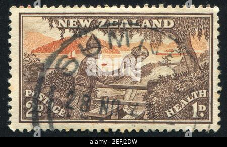 NEW ZEALAND - CIRCA 1945: stamp printed by New Zealand, shows Soldier Helping Child over Stile, circa 1945 Stock Photo