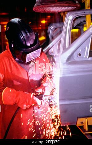 Automobile factory mechanic working on chassis in a shower of sparks Stock Photo