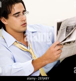 Close-up of a businessman reading a newspaper Stock Photo