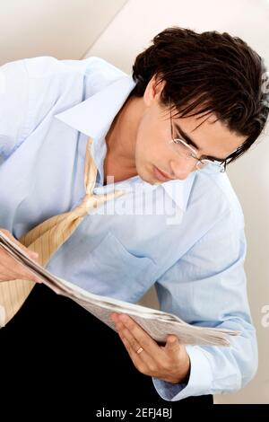 Close-up of a businessman reading a newspaper Stock Photo