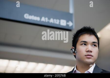 Low angle view of a businessman wearing a hands free device Stock Photo