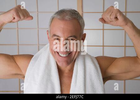 Portrait of a senior man flexing his muscles Stock Photo