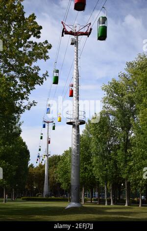 Brightly colored cable cars carry tourists. Running on wires supported by steel pylons, it is the longest cable car route. gondola cabins suspended ca Stock Photo