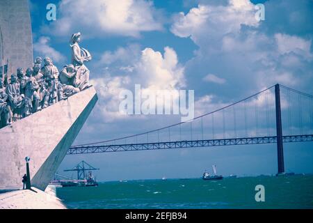 Statues in front of a bridge, Monument to the Discoveries, Belem, Lisbon, Portugal Stock Photo