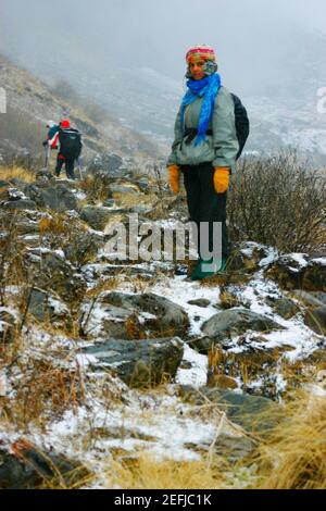Portrait of a female hiker standing on a mountain, Machhapuchhare, Annapurna Range, Himalayas, Nepal Stock Photo