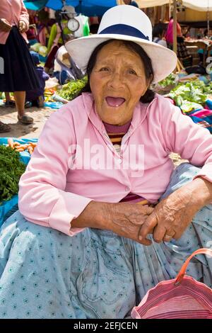 Portrait of a senior woman crouching at a market stall, Peru Stock Photo