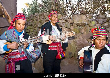 Three guitarists performing, Lake Titicaca, Taquile Island, Puno, Peru Stock Photo