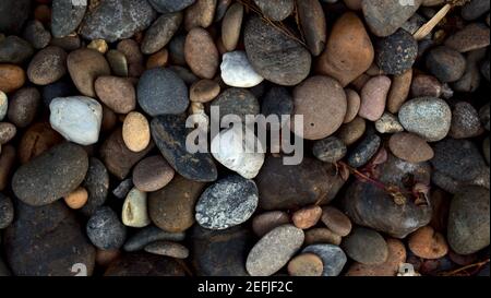 Natural multicolored pebbles stone abstract texture background. Stock Photo